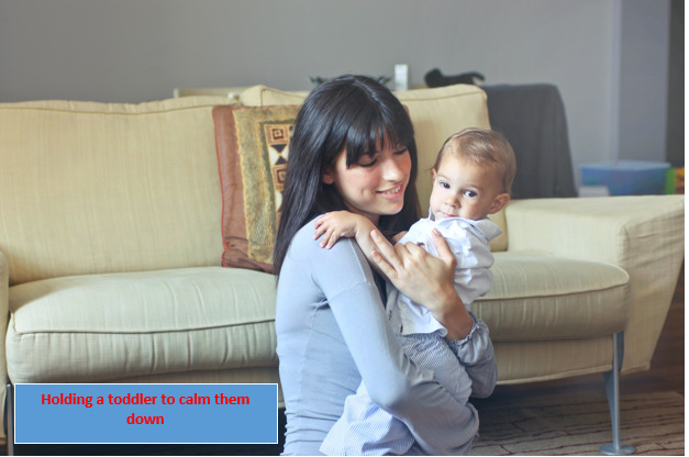 Holding toddler to calm them down